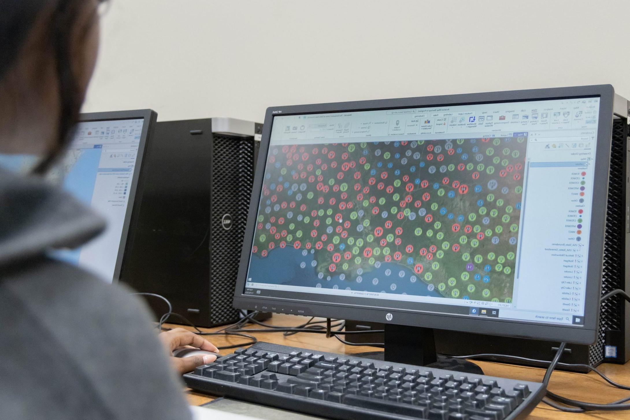 A computer screening showing a large database of plotted points on a geographic area in ArcGIS software.